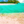 Tableau décoratif représentant une plage tropicale aux eaux turquoise, bordée de sable clair, de palmiers et d’une végétation luxuriante- Tableau décoratif en plexiglas