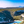 Tableau décoratif d’un paysage naturel avec crique turquoise, collines verdoyantes et montagnes sous un ciel bleu - Plexiglas - ESPOIR PHOTOS