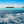 Tropical island with palm trees and turquoise sea under blue sky, scenic ocean landscape