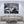 Modern living room with beige furniture, large black and white cityscape photo on wall