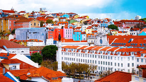 Colorful cityscape with red rooftops, vibrant buildings, and historic architecture