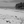 Black and white photo of empty tropical beach with palm trees and person walking on the sand