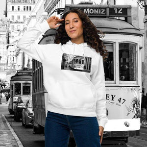Woman wearing white eco-friendly unisex raglan hoodie with vintage tram print, city street